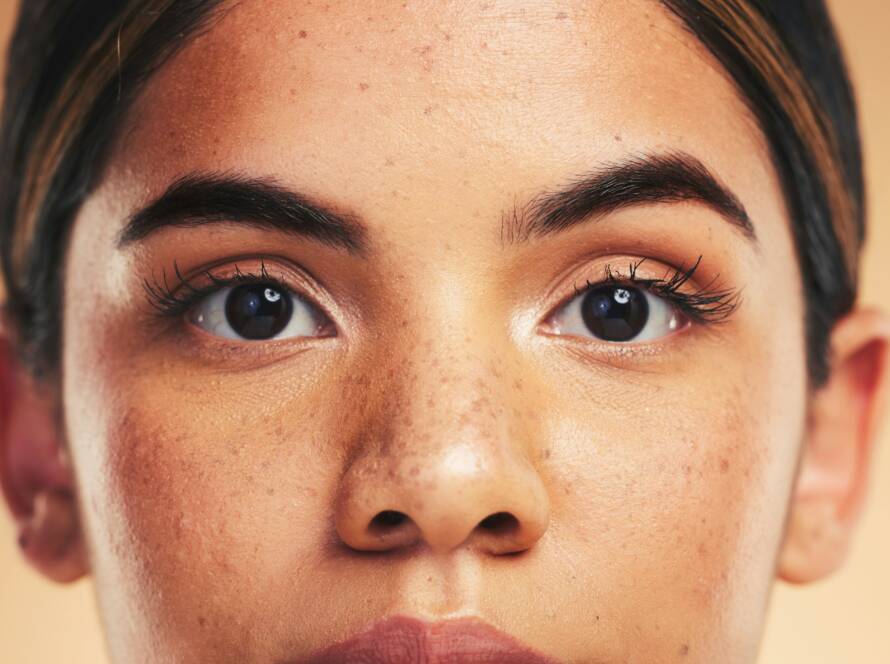 Woman, skin and closeup in studio portrait with beauty, cosmetics and natural glow on face by backg