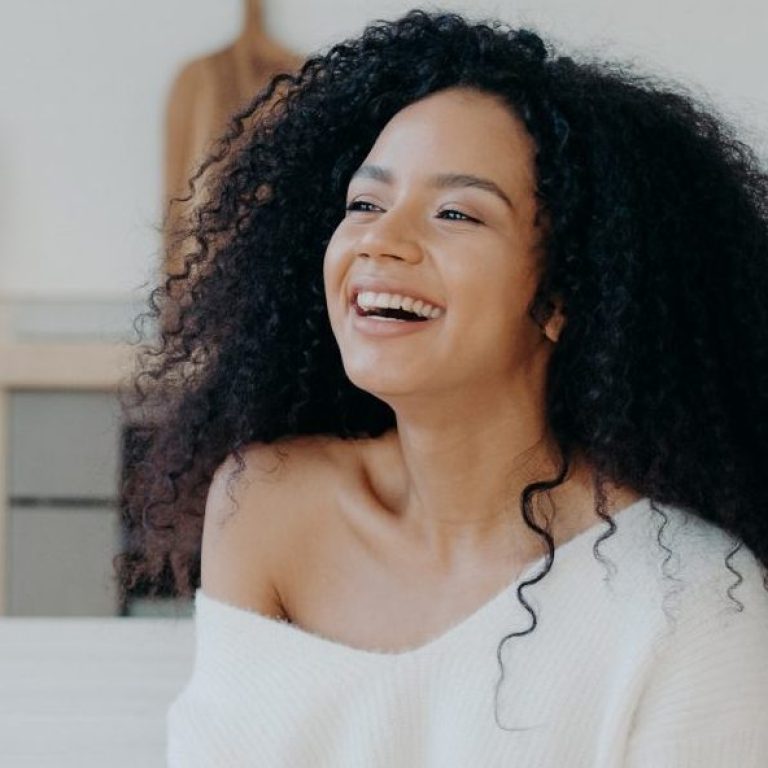 horizontal shot overjoyed dark skinned woman laughs pleasantly drinks coffee looks out window kitchen dressed fashionable clothes smiling lady with hot tasty beverage relaxes home scaled e1767760615283 aesthetic medical spa treatment McLean VA En Santé Med