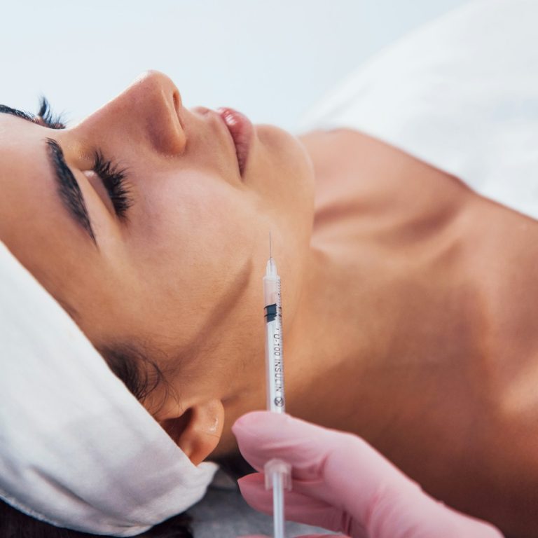 woman that lying down in spa salon and have injection by the syringe into her face skin aesthetic medical spa treatment McLean VA En Santé Med